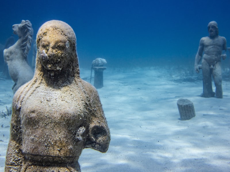 Diver documenting submerged sphinx fragment at Canopus